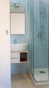 a bathroom with a sink and a glass shower at Antica Capua Bed and Breakfast in Santa Maria Capua Vetere
