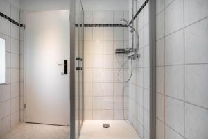 a shower with a glass door in a bathroom at Wohnung Obergeschoss in Funfseen +18 photos