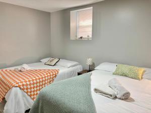 a bedroom with two beds and a window at FREE Parking near NYC Washer and Dryer in North Bergen +35 photos