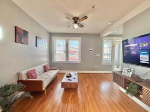 a living room with a couch and a flat screen tv at FREE Parking near NYC Washer and Dryer in North Bergen