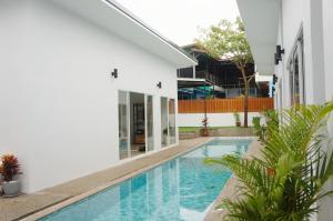 an external view of a house with a swimming pool at A&J Holiday Villa in Ban Na Bon