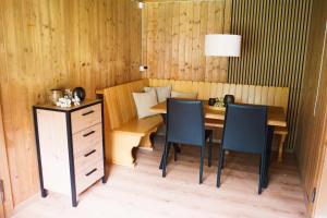 a dining room with a table and two chairs at Ferienhaus Auen 37 in Matt