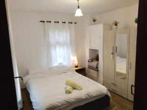 a bedroom with a bed and a cabinet and a window at Balkan Mountains Villa Spa in Elena