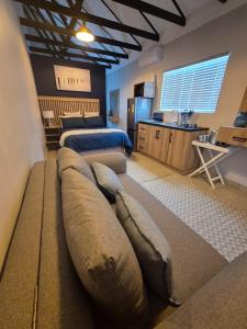 a large bedroom with two beds and a kitchen at atnine in Welkom