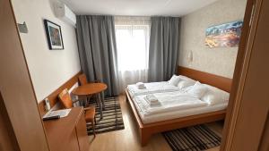 a hotel room with a bed and a table at Hotel ROSE Břeclav in Břeclav +35 photos