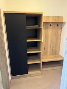 a closet with wooden shelves in a room at Hotel ROSE Břeclav in Břeclav +35 photos