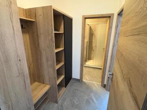 a room with an open door and a closet at Hotel ROSE Břeclav in Břeclav