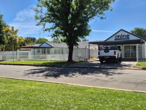 a white truck parked in front of a building at atnine in Welkom