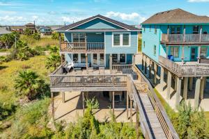an aerial view of a blue house with decks at Blue Waves - Beachside Calm, Gulf Views for Miles in Freeport