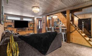 a living room with a couch and a television at Copper Kettle Lodge in Cook Forest in Sigel