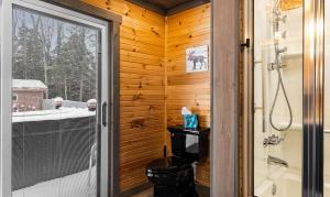 a bathroom with a shower and a glass door at Copper Kettle Lodge in Cook Forest in Sigel +47 photos