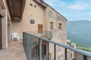a balcony of a building with a chair on it at Casa Vilanova in Peramea