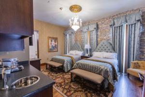 a bedroom with two beds and a sink in it at PA Smith Hotel in Navasota