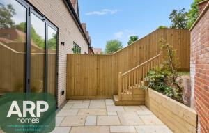 an entrance to a home with a wooden fence at Spacious 3bd l Family Home in Coulsdon