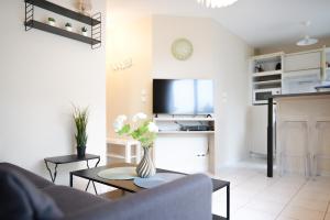 una sala de estar con un sofá y una mesa en Appartement cœur de ville avec balcon - 3 personnes, en Les Sables-dʼOlonne