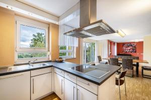 GäufeldenにあるFerienwohnung Gäufelden 120 Qmのシンクと大きな窓のあるキッチン