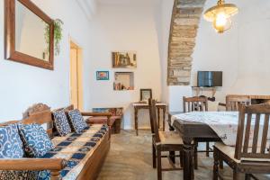 a living room with a couch and a table at Kykladen White House in Koumáros
