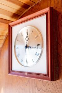a clock is hanging on a wall at SS Mindy - A Unique Tombstone Stay in Tombstone