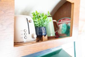 a shelf with a toaster and cups on it at SS Mindy - A Unique Tombstone Stay in Tombstone