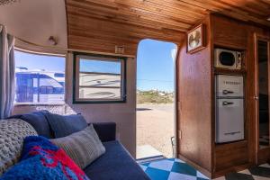 a living room with a blue couch in an rv at SS Mindy - A Unique Tombstone Stay in Tombstone