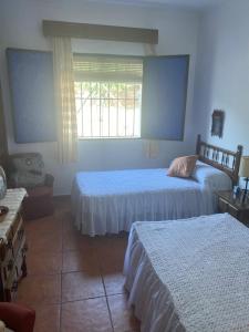a bedroom with two beds and a window at Casa Froscar in Bermejo +18 photos