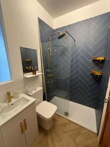 a bathroom with a shower and a toilet and a sink at Seaview Surf Studios in Newquay