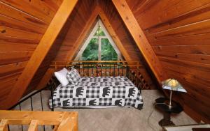 a bedroom in a log cabin with a bed and a window at Shepherds Crook 1127 in Gatlinburg +49 photos