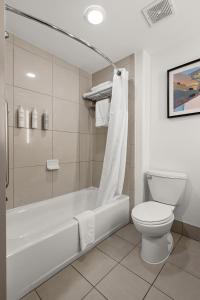 a bathroom with a tub and a toilet and a shower at Hilton Garden Inn New Braunfels in New Braunfels