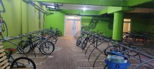 a group of bikes parked in a room with green walls at Ap mobiliado reg central de São Paulo in São Paulo