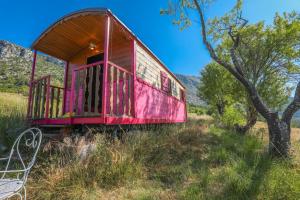un wagon rouge posé au sommet d'un champ dans l'établissement Roulotte Ferme Saint-Pierre, à Bargème