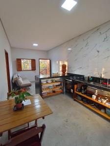 a large room with a table and a counter at Chalés Refúgio da Sil in Cavalcante +49 photos