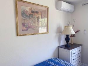 a bedroom with a picture and a bed and a dresser at Pomona Cozy Queen Bedroom in Pomona