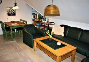 a living room with a couch and a table at Haus Halligblick in Dagebüll