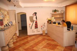 a woman sitting at a counter in a salon at Retro Hostel in Cluj-Napoca