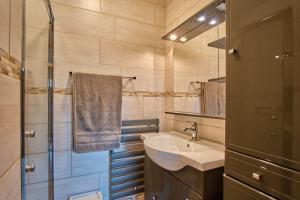 a small bathroom with a sink and a shower at La Croix Du Sud in Villard-de-Lans +15 photos