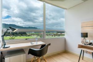 an office with a desk and a large window at Pop Art Hotel Tocancipá y Centro de Convenciones in Tocancipá