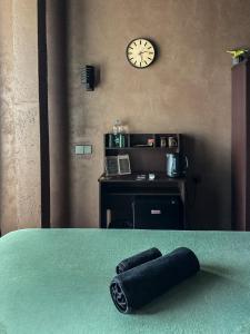a roll of black thread sitting on a table with a clock at Arana Weligama in Weligama