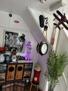 a room with a desk and a clock on the wall at The Southwold Guest House in Skegness