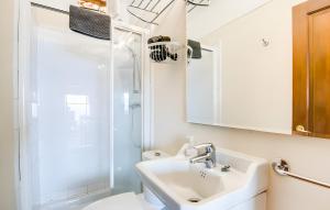 a white bathroom with a sink and a shower at Cala Deia in Deia +22 photos