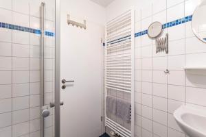 a bathroom with a toilet and a sink at Fewo Zur Piste in Willingen +17 photos