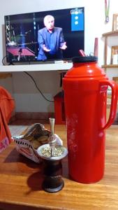 a red tea pot and a cup on a table at San Martin Apart in Puerto Rico