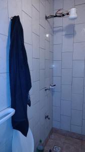 a bathroom with a shower with a blue towel at San Martin Apart in Puerto Rico