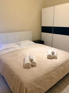 ein Schlafzimmer mit einem Bett mit Handtüchern darauf in der Unterkunft Cozy Apartment 150 m from Târgu Mureș Hospital in Târgu Mureș