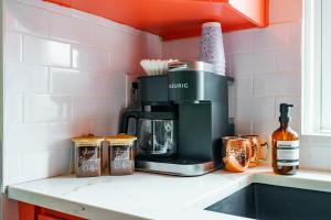 a coffee maker on a counter in a kitchen at Prime Location Top Rated Clean Parking Free! in Columbus