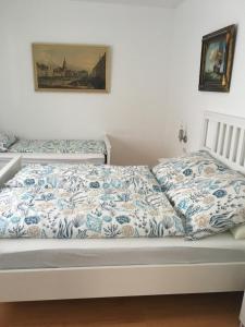 a bed with blue and white sheets on it at Ferienhaus Gumann in Nuremberg