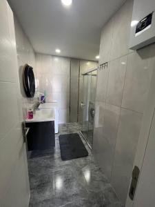 a bathroom with a shower and a sink at Sea and Natural Adalet Suits in Çağlayan