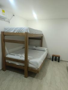 a bunk bed in a room with a white wall at Mango Beach in San Bernardo del Viento