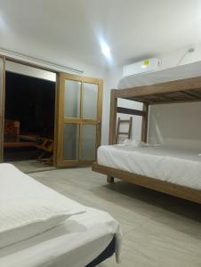a bedroom with two bunk beds and a window at Mango Beach in San Bernardo del Viento