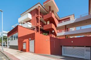 an orange building with stairs on the side of it at Gavade Apartamento in Puertito de Güímar