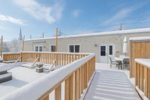 a deck with chairs and a table on a house at Downtown - Rooftop patio - Free shuttle to ski Mountain in Mont-Tremblant